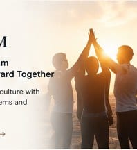 Silhouettes of team members high-fiving at sunset
